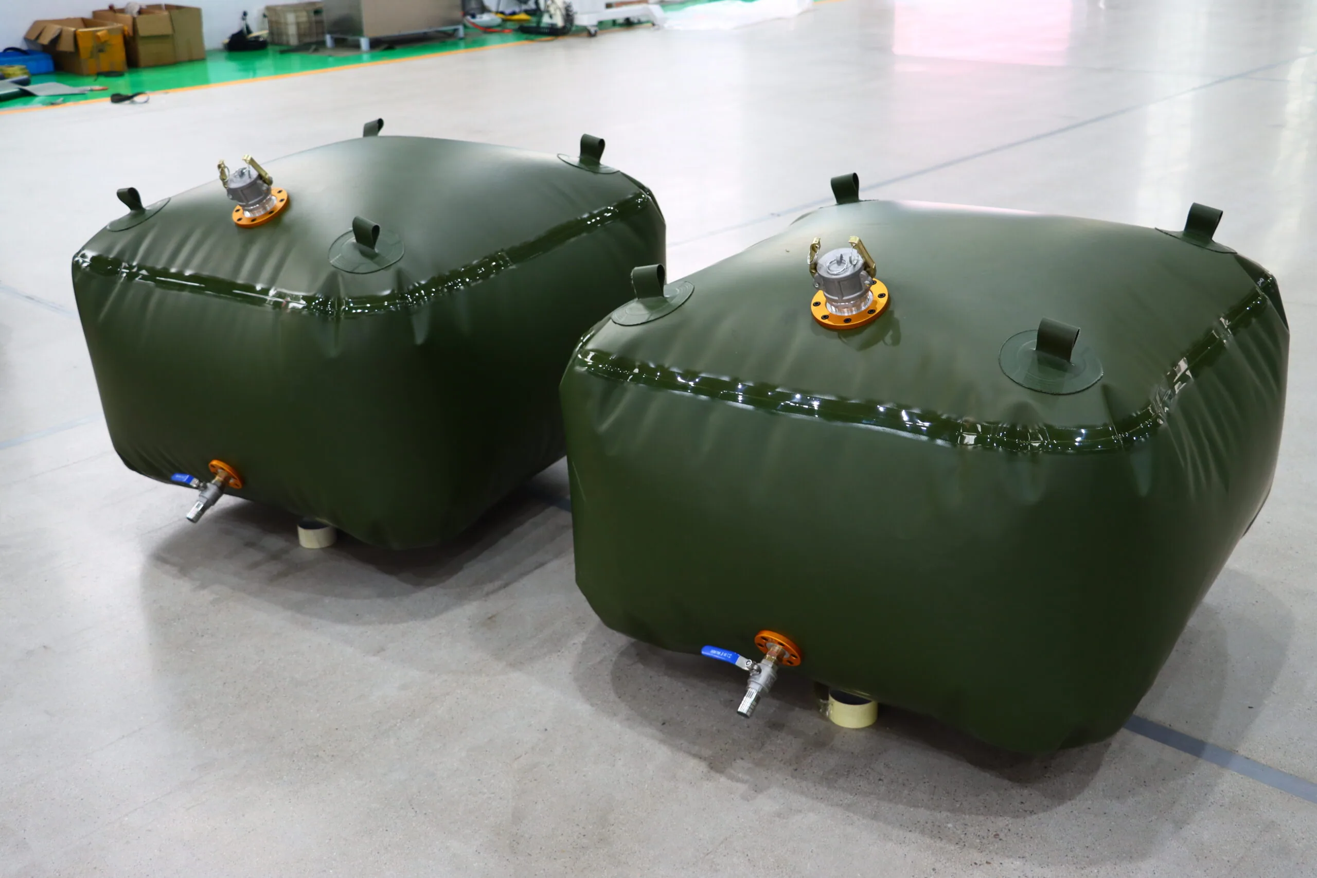 Green flexible fuel bladder tanks with outlet fittings
