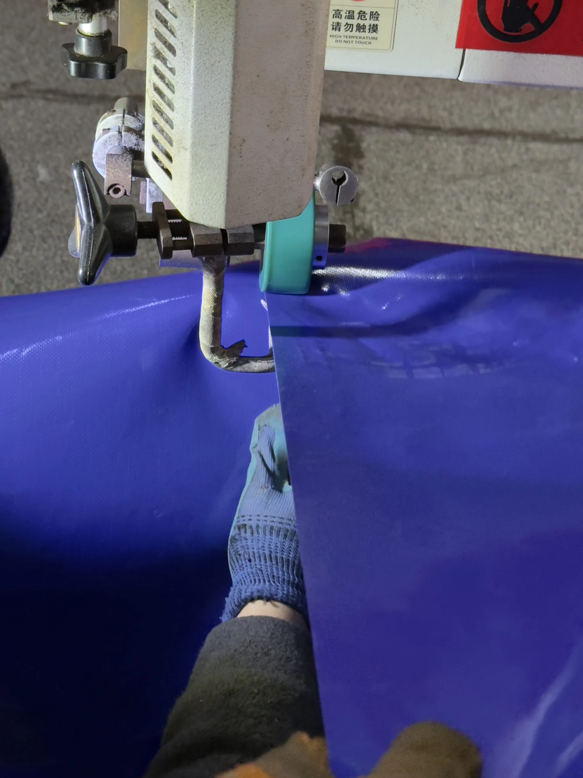 Valve assembly being fitted to a blue flexible water bladder