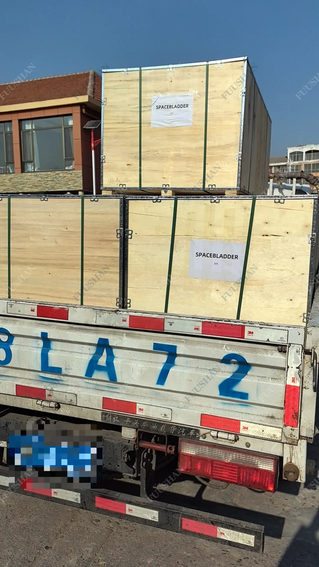 Crated fish tank units loaded onto a truck