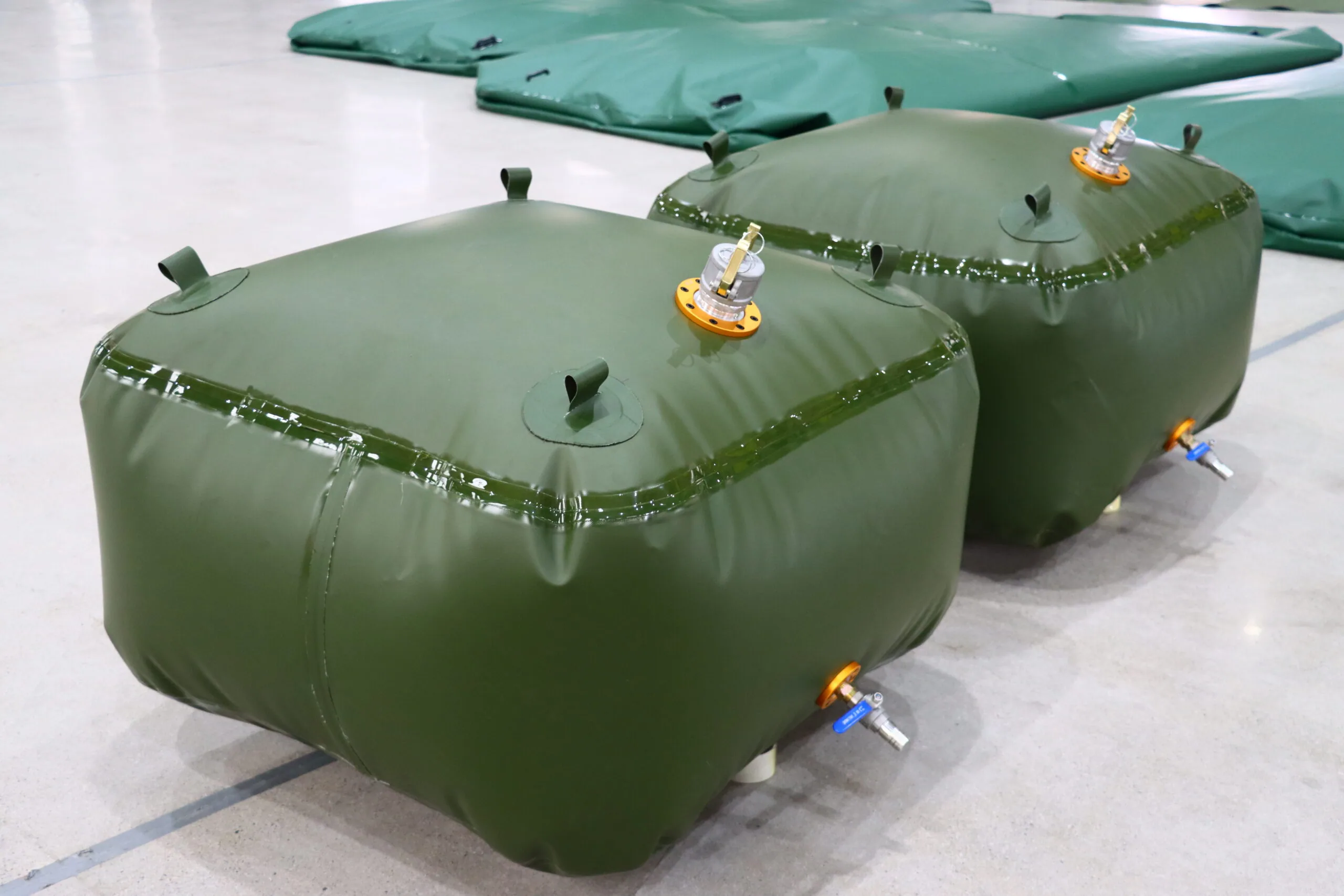 Green flexible fuel bladder tanks with outlet fittings