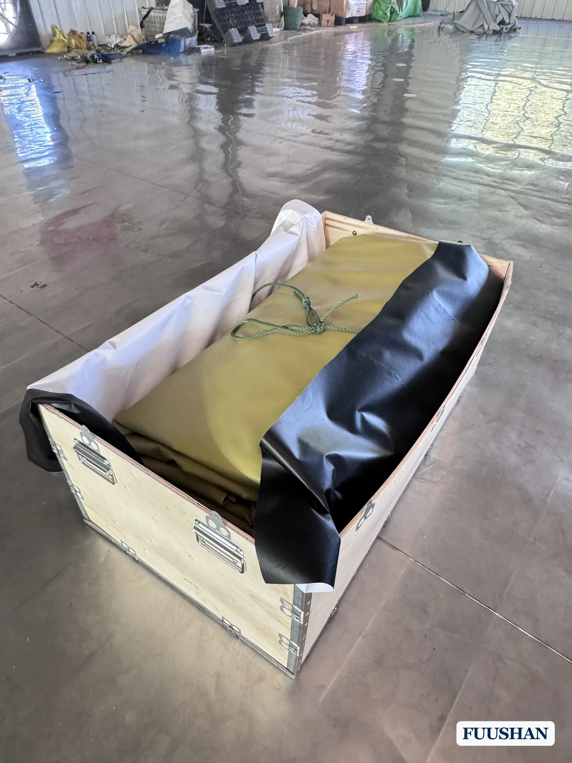 Folded pillow water bladder covered and packed inside a wooden export crate