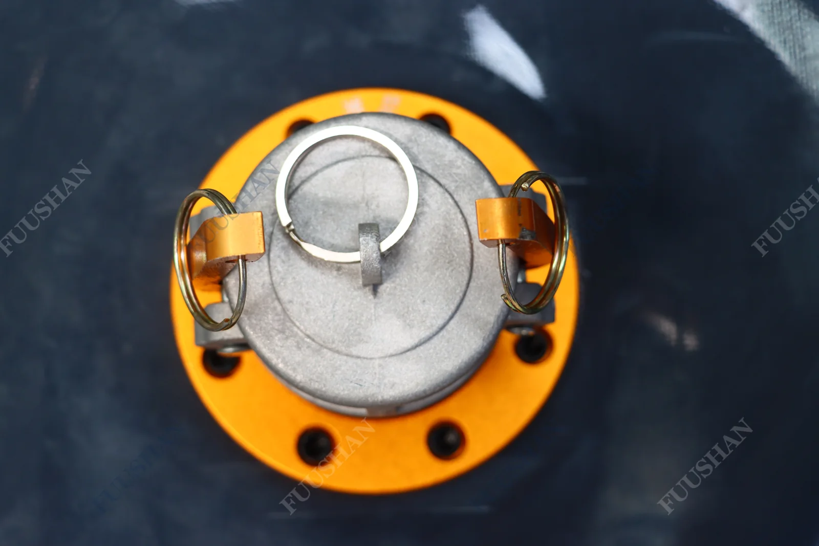 Metal fitting with a retaining-ring cap on an orange circular flange