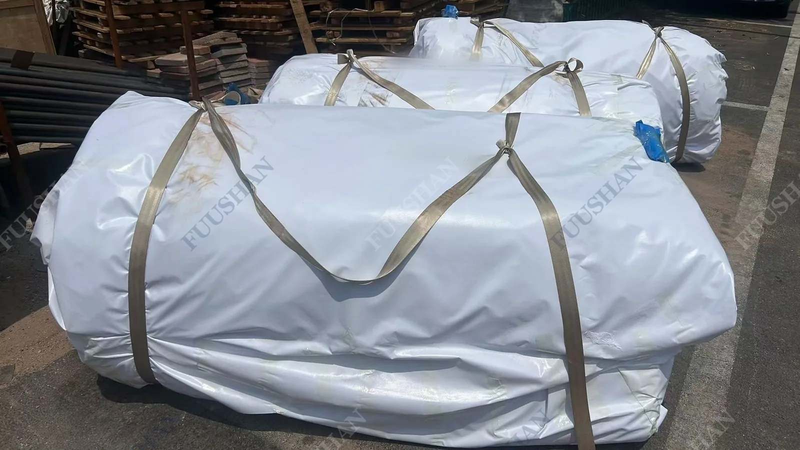 Tank units wrapped in white sheeting and strapped